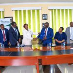 PAKPRO CEO Joyce Gachugi-Waweru shakes hands with Kenya Scouts Association Chief Commissioner Victor Radido during the launch of the Tuwezeshe Schools Program in Nairobi.