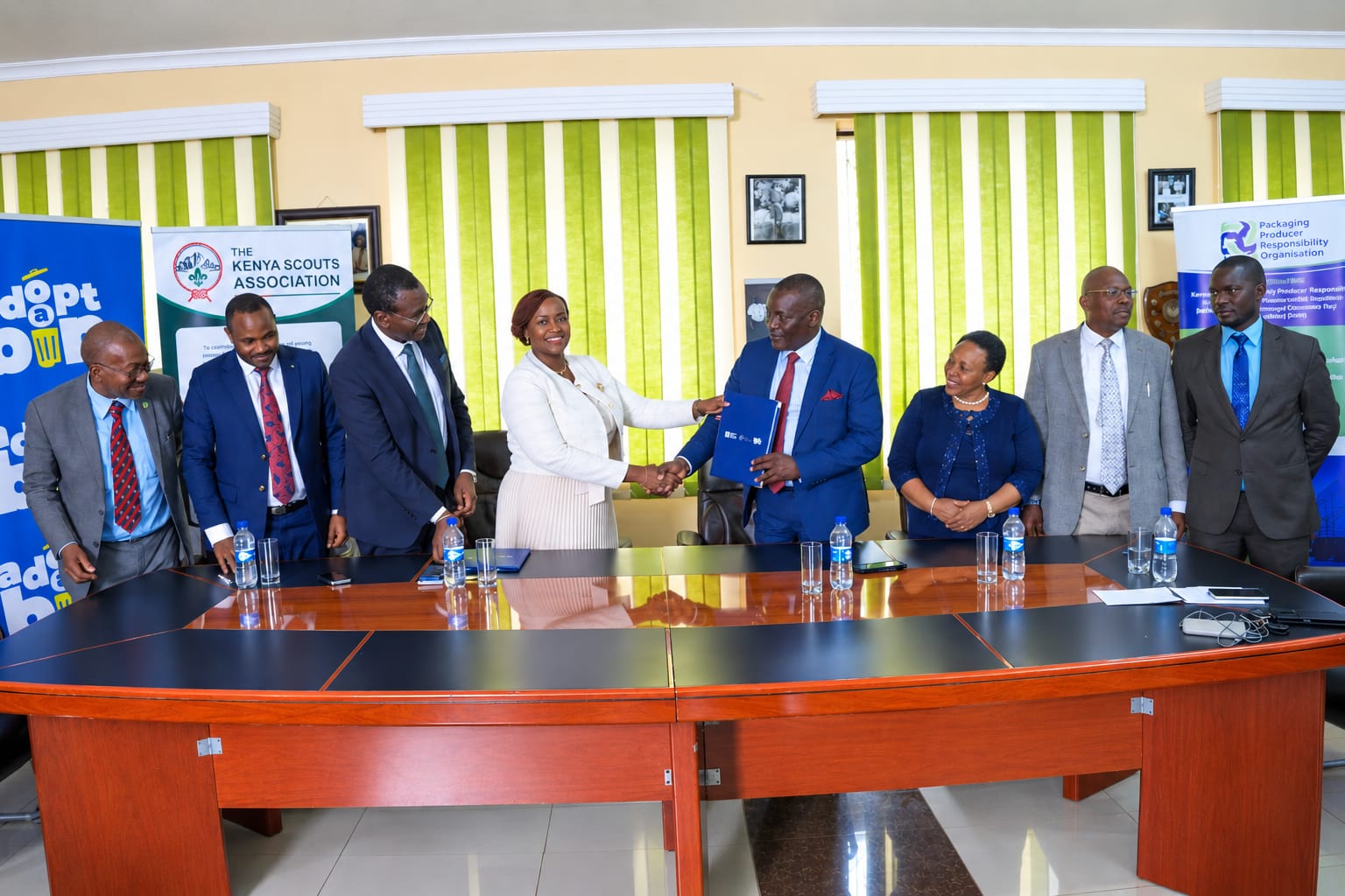 PAKPRO CEO Joyce Gachugi-Waweru shakes hands with Kenya Scouts Association Chief Commissioner Victor Radido during the launch of the Tuwezeshe Schools Program in Nairobi.